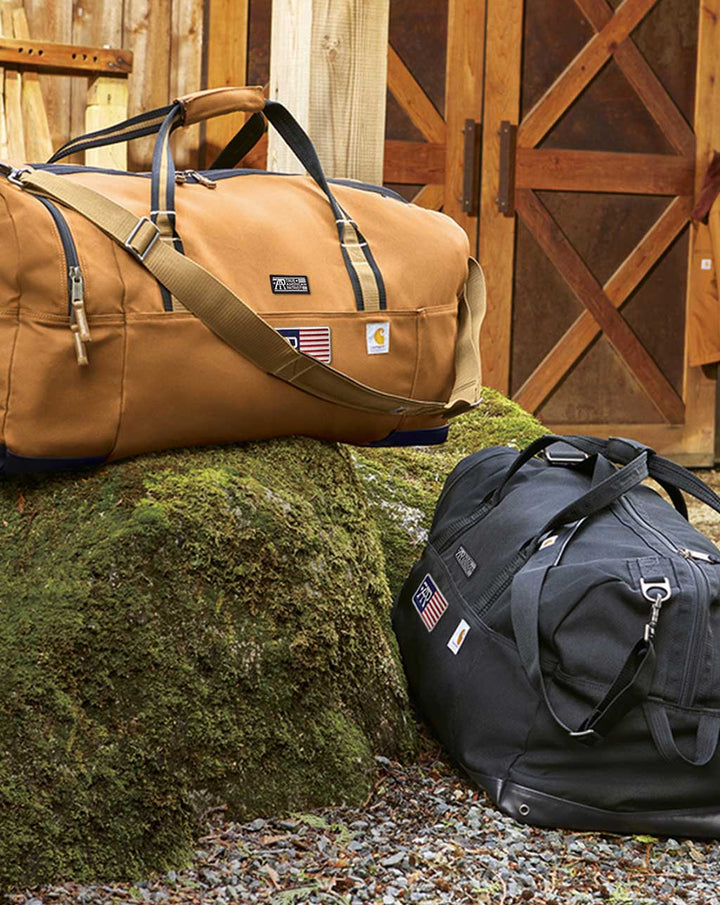 True American Patriot Mfg. x Carhartt 120L heavy-duty duffel bag with American flag patch and rugged work-ready construction.