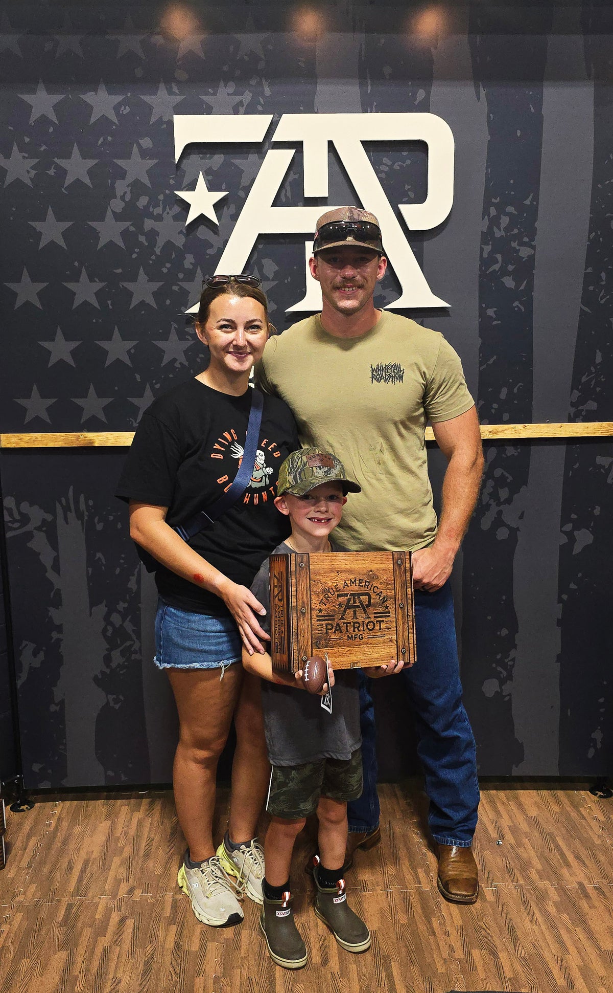 Family posing with a TAP giveaway prize at Georgia Buckarama