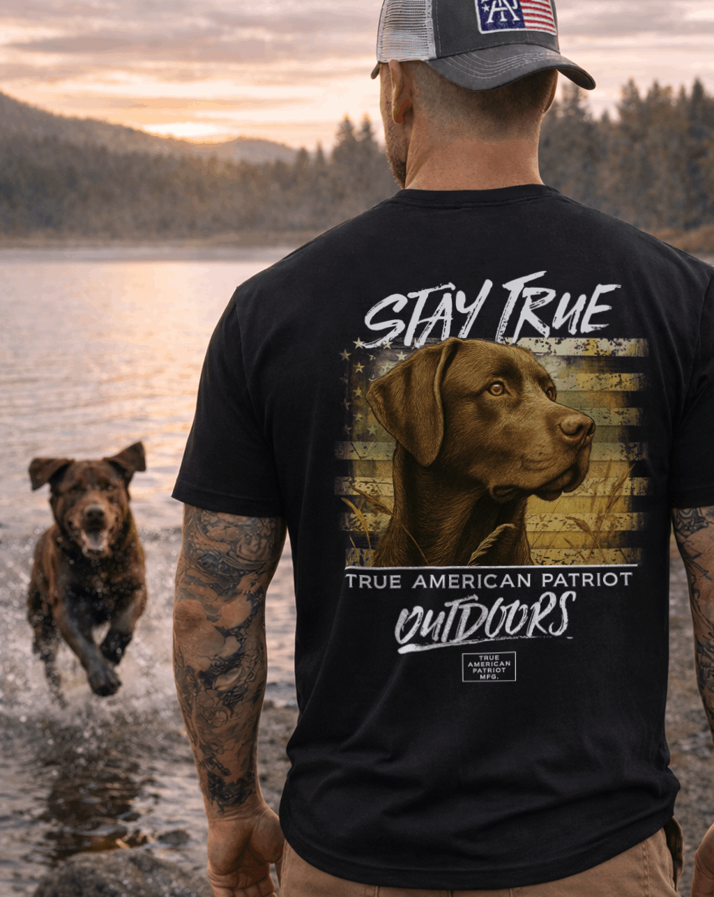 Man wearing a True American Patriot Mfg - Stay True Chocolate Lab Tshirt with a Lab running out of the water