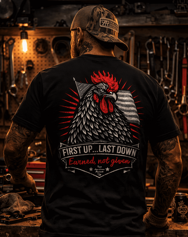 Man in workshop wearing a True American Patriot Mfg Patch Cap and First Up...Last Down Tee