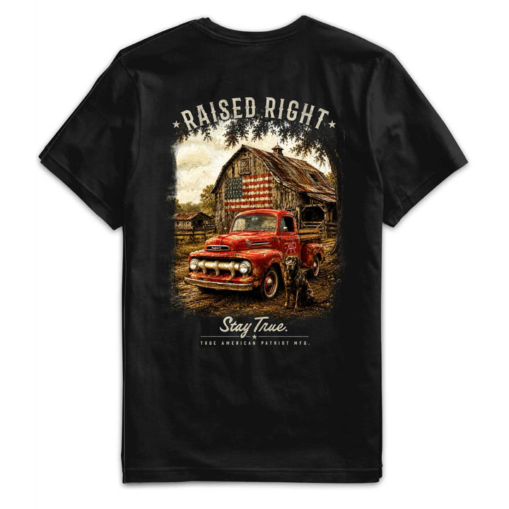 Back flat of the Raised Right graphic tee featuring a vintage red pickup truck, American flag barn, hunting dog, and Stay True artwork. Heritage Collection by True American Patriot MFG.