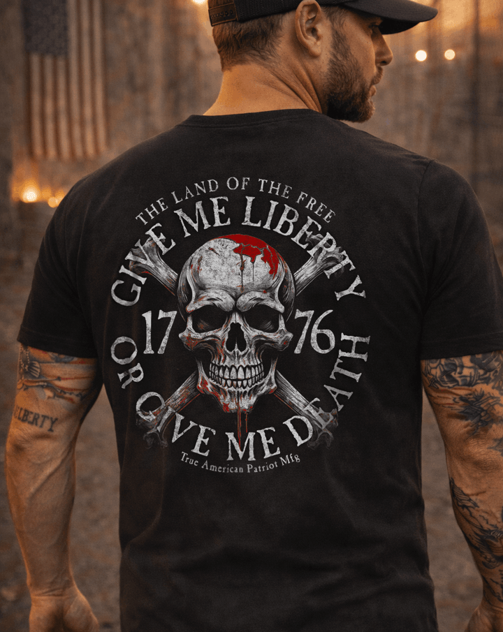 Man wearing True American Patriot Mfg Give Me Liberty or Give Me Death Black Tshirt with Patriotic Background