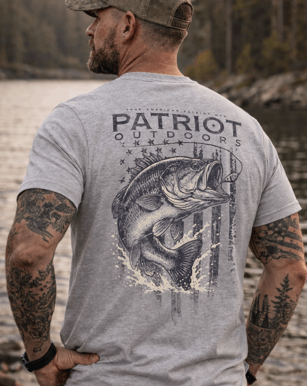 Man wearing True American Patriot Mfg - Largemouth Bass Outdoors standing in front of Lake