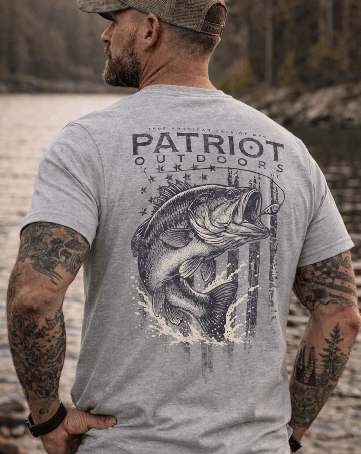 Man wearing True American Patriot Mfg - Largemouth Bass Outdoors standing in front of Lake