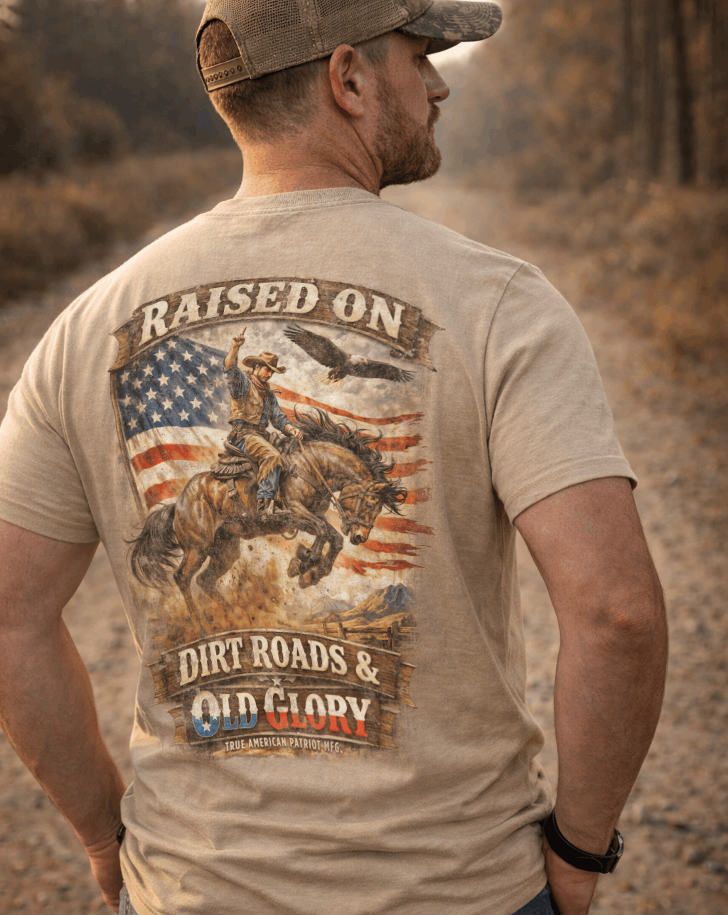 Man on dirt road wearing a True American Patriot Mfg Raised on Dirt Roads & Old Glory Tee