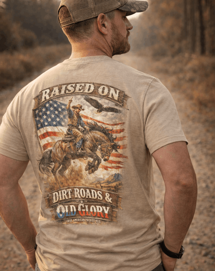 Man on dirt road wearing a True American Patriot Mfg Raised on Dirt Roads &amp; Old Glory Tee