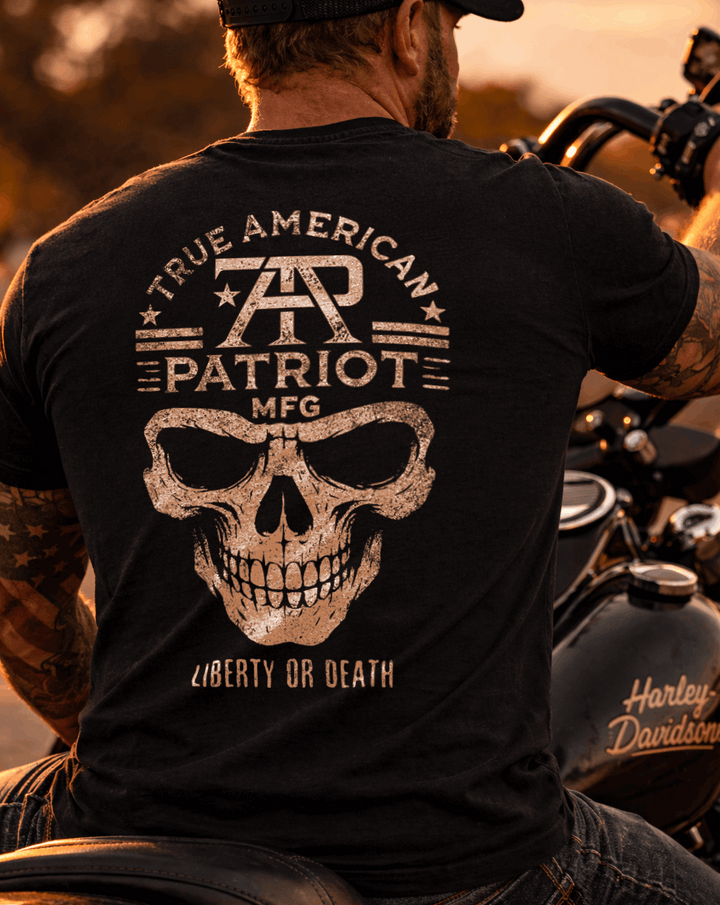 Man on Harley Davidson motorcycle wearing a True American Patriot Mfg - TAP Skull LIberty or Death Tee
