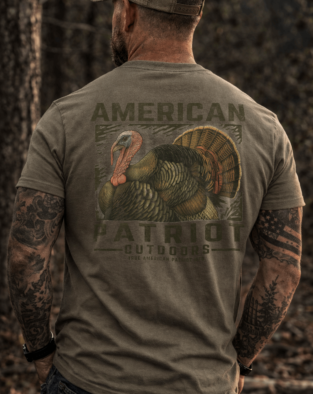 masculine person wearing a True American Patriot Mfg - Outdoors - Wild Turkey Tee standing in the woods