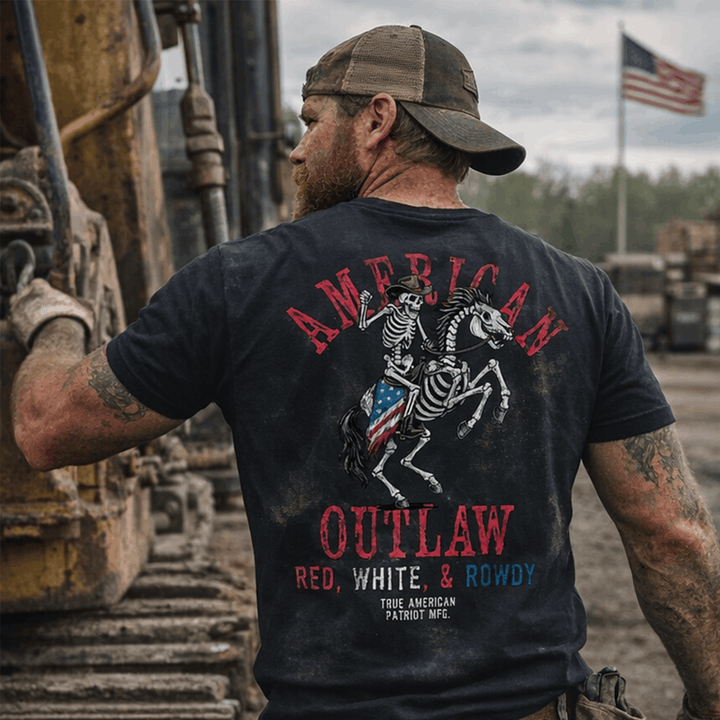 Man wearing True American patriot American Outlow Red, White, &amp; Rowdy Tee on jobsite with American flag in background