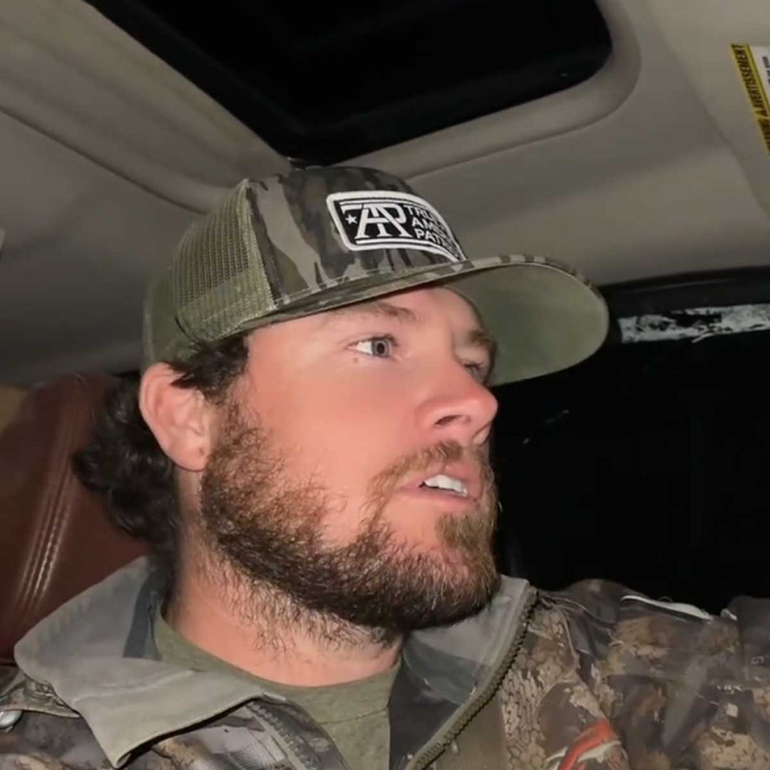 True American Patriot MFG camo patch hat worn inside a pickup truck